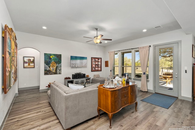 living area with a ceiling fan, recessed lighting, baseboards, and light wood finished floors