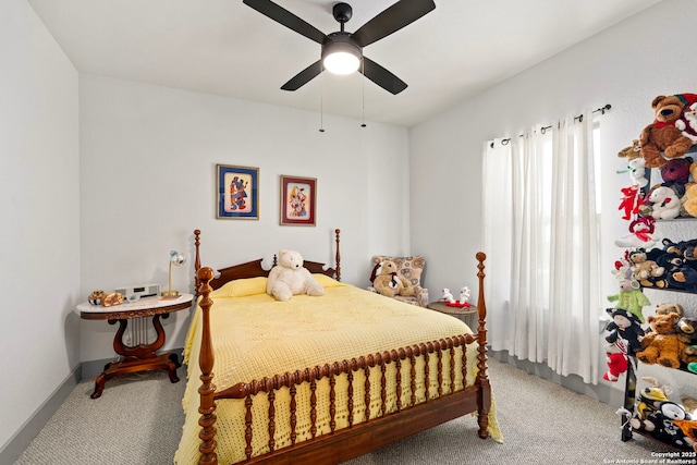 bedroom featuring baseboards, a ceiling fan, and light colored carpet