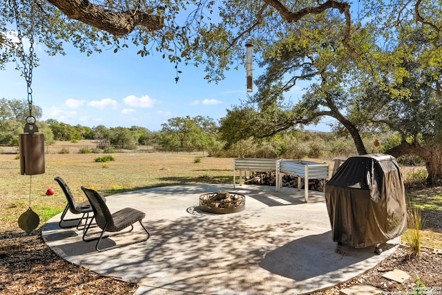 view of patio with a grill and a fire pit