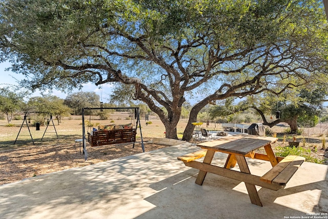 view of property's community featuring a patio area and outdoor dining space