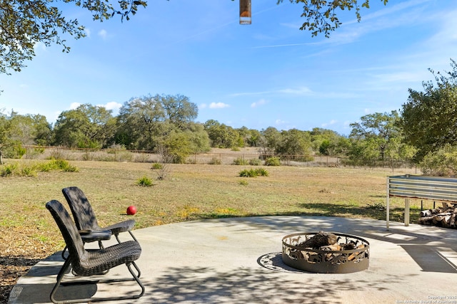 view of patio / terrace featuring an outdoor fire pit and fence