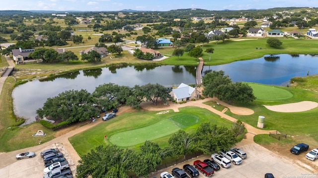 birds eye view of property with a water view and golf course view