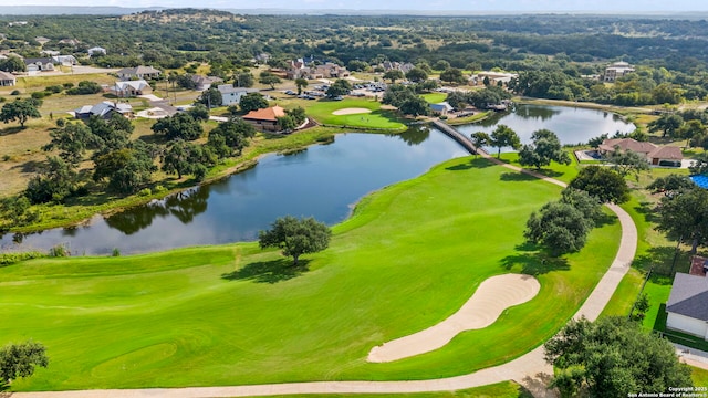 aerial view featuring golf course view and a water view