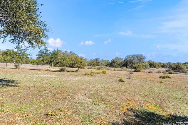 view of yard with a rural view and fence