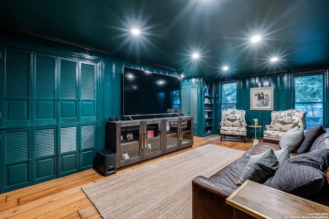 living area with recessed lighting, wood finished floors, and crown molding