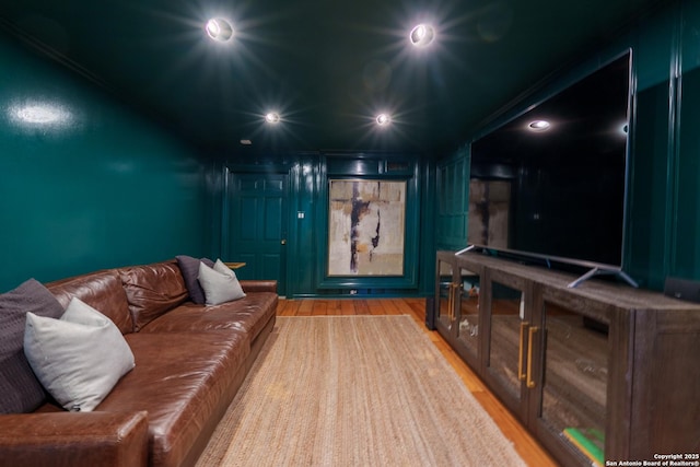 cinema room with wood finished floors and recessed lighting