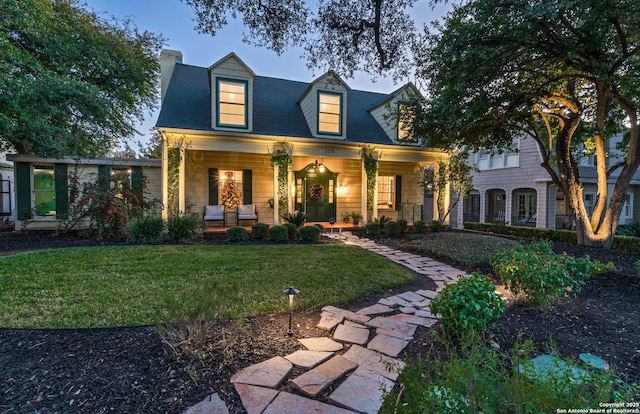 view of front of home featuring a porch and a front lawn