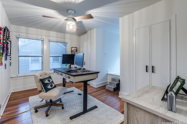 office with wood finished floors, a ceiling fan, and baseboards