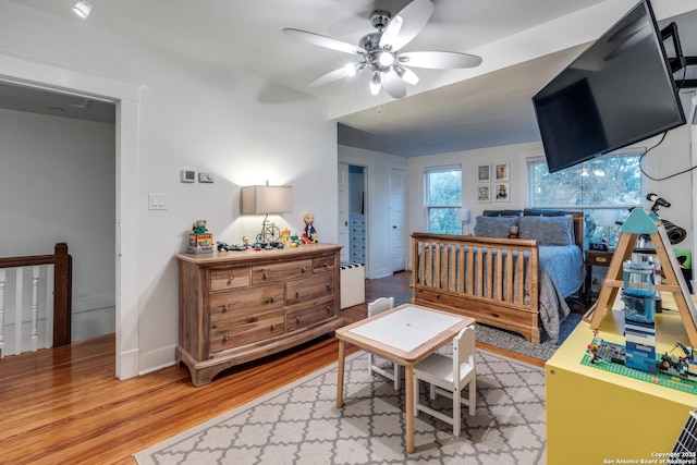 bedroom featuring wood finished floors and baseboards