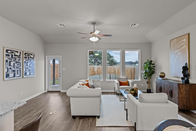 living room featuring ceiling fan, wood finished floors, visible vents, and baseboards