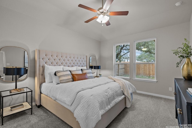 bedroom with vaulted ceiling, ceiling fan, carpet, and baseboards