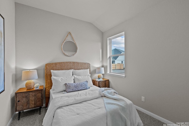 bedroom with lofted ceiling, baseboards, and carpet