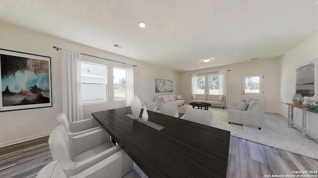 dining area with wood finished floors and visible vents