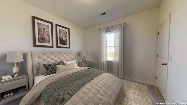 bedroom featuring carpet floors, visible vents, and baseboards