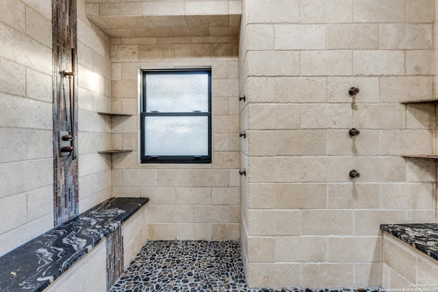 full bath with a tile shower