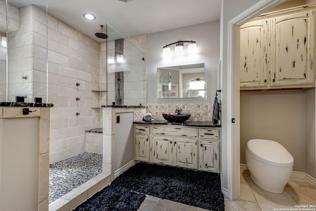 full bathroom featuring baseboards, a walk in shower, backsplash, and vanity