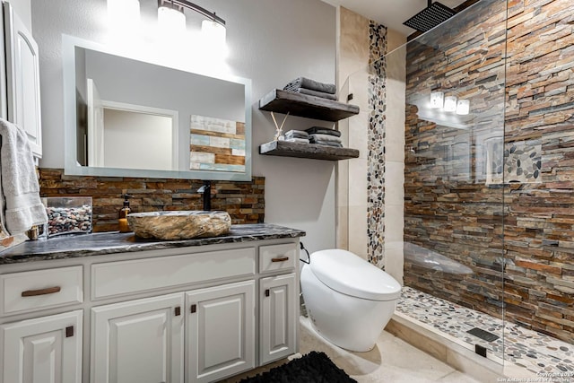 bathroom with a walk in shower, toilet, and vanity