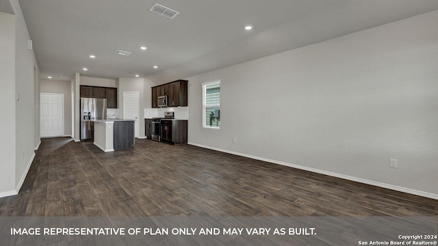 kitchen featuring dark brown cabinetry, stainless steel appliances, visible vents, open floor plan, and dark wood-style floors