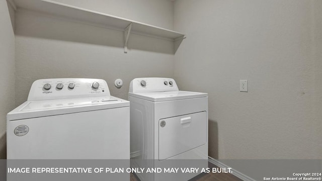 washroom featuring laundry area and washing machine and clothes dryer