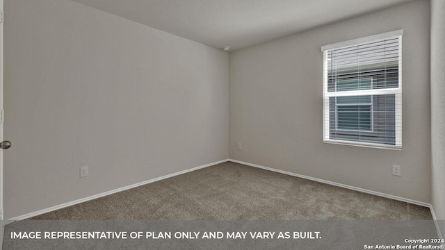 unfurnished room with carpet flooring and baseboards