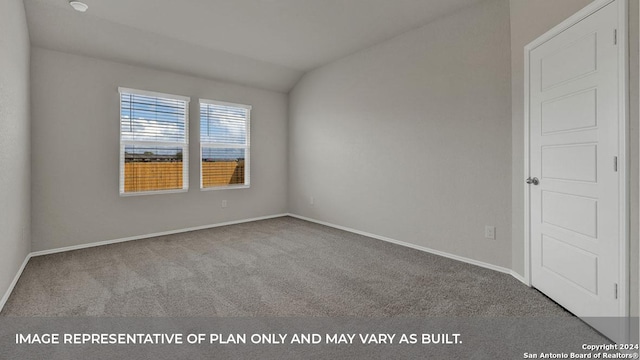 spare room featuring lofted ceiling, carpet flooring, and baseboards