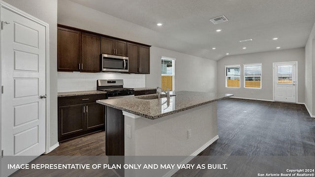 kitchen featuring light stone counters, dark brown cabinetry, dark wood-style flooring, visible vents, and appliances with stainless steel finishes