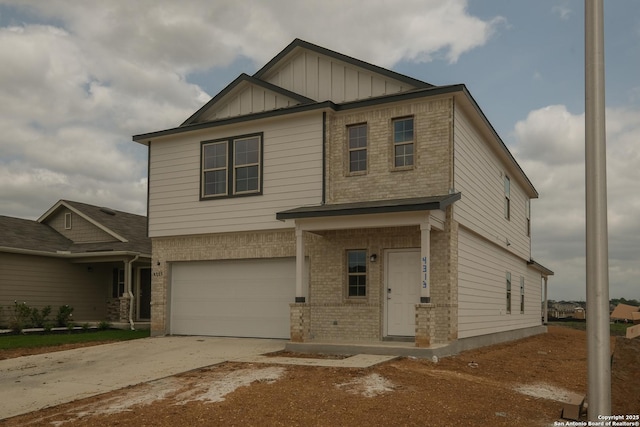 craftsman house featuring board and batten siding, an attached garage, brick siding, and driveway