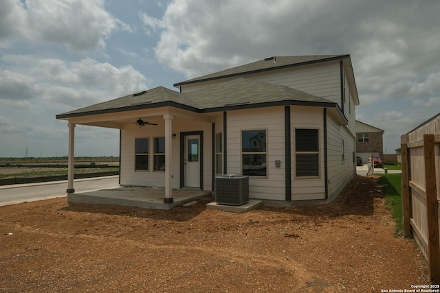 rear view of house featuring central AC unit, a ceiling fan, and a patio area