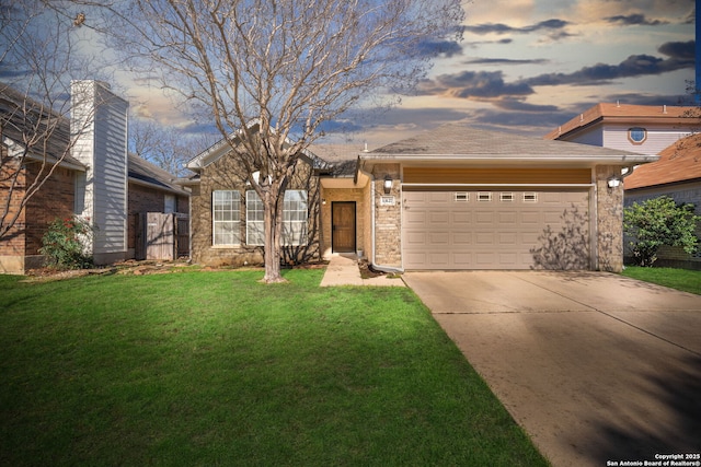 ranch-style home with driveway, an attached garage, and a front yard