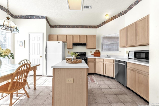 kitchen featuring a center island, light brown cabinetry, appliances with stainless steel finishes, a sink, and a textured ceiling