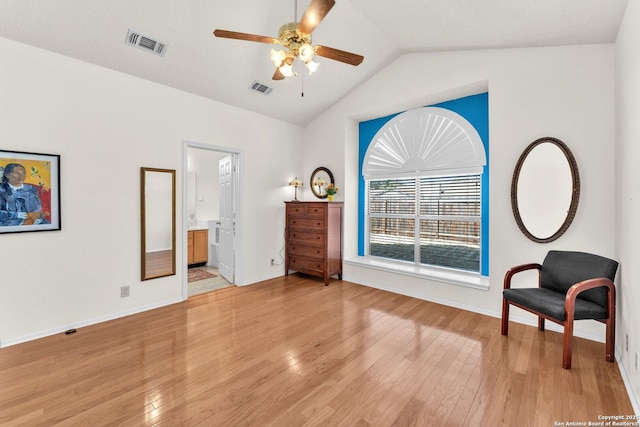 bedroom featuring light wood-type flooring, baseboards, visible vents, and vaulted ceiling