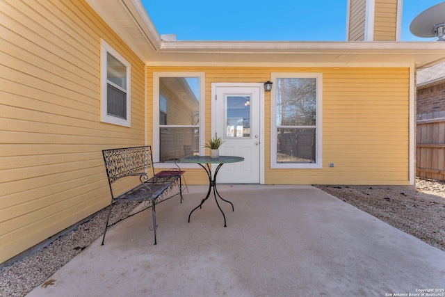 entrance to property featuring a patio and fence