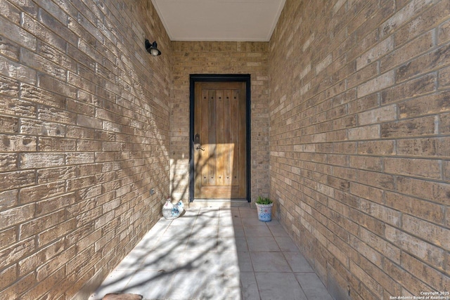 property entrance with brick siding