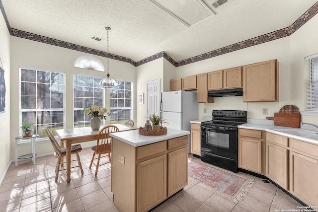 kitchen with black range with electric stovetop, freestanding refrigerator, light brown cabinets, a sink, and under cabinet range hood