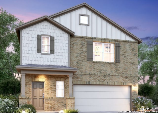 view of front facade featuring a garage, driveway, brick siding, and board and batten siding