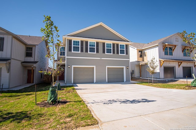 view of front of house featuring an attached garage, driveway, and a front lawn