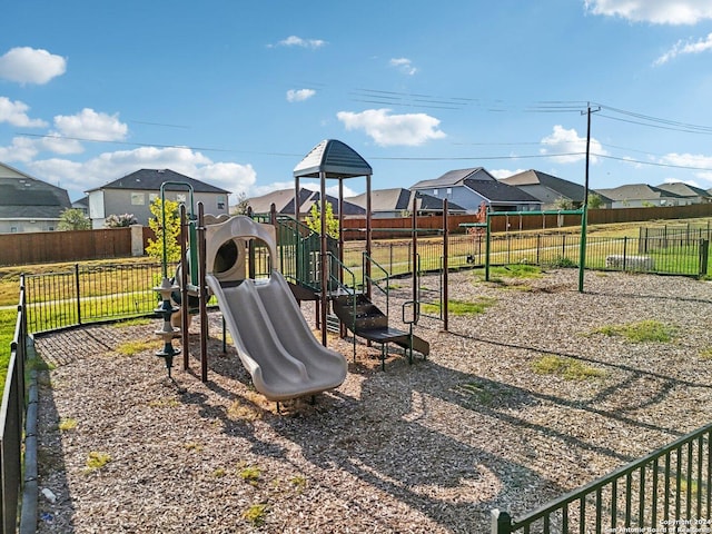 view of jungle gym featuring a residential view and fence