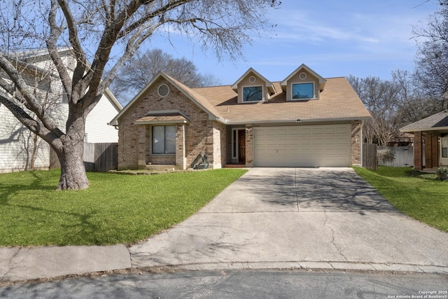 view of front of property featuring driveway, a garage, fence, and a front yard