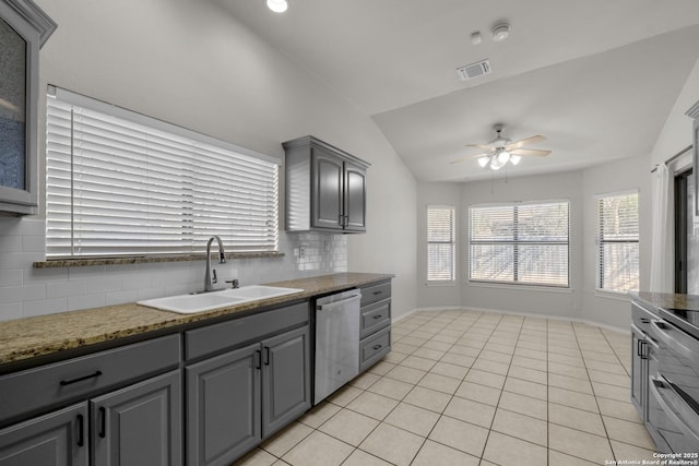 kitchen with lofted ceiling, a sink, visible vents, gray cabinets, and dishwasher