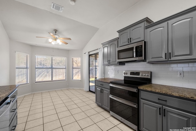 kitchen with light tile patterned floors, tasteful backsplash, gray cabinets, visible vents, and appliances with stainless steel finishes