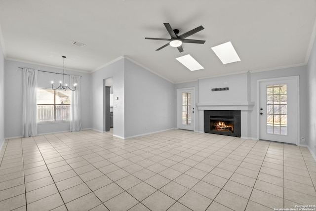 unfurnished living room with crown molding, plenty of natural light, light tile patterned flooring, and a fireplace