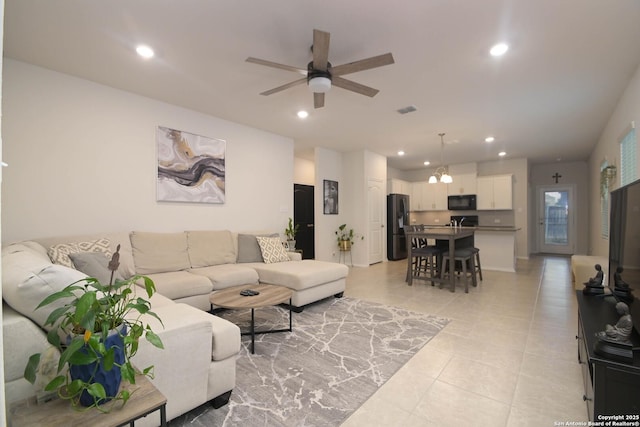 living room featuring a ceiling fan, recessed lighting, light tile patterned flooring, and visible vents