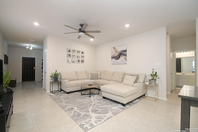 living room with baseboards, light tile patterned floors, a ceiling fan, and recessed lighting