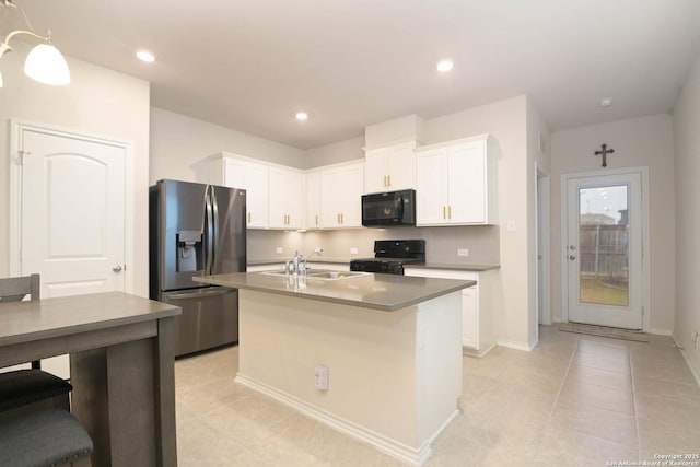 kitchen featuring an island with sink, black appliances, white cabinetry, a sink, and recessed lighting