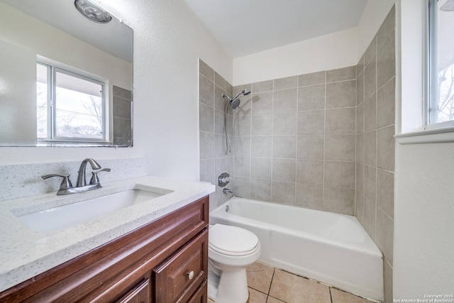 bathroom featuring plenty of natural light, vanity, toilet, and tile patterned floors