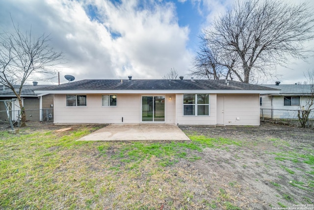 rear view of property featuring a patio, a yard, and a fenced backyard