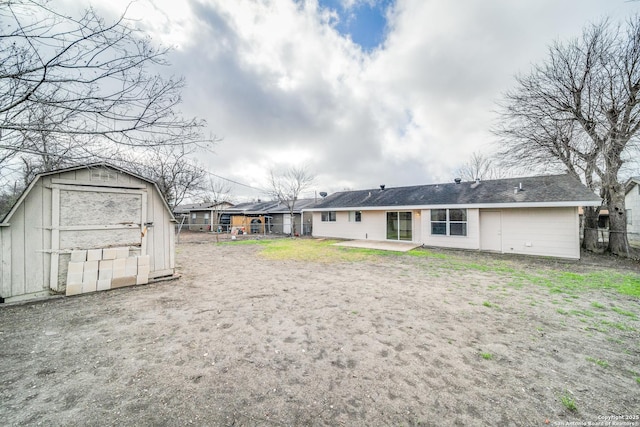 back of house with a patio area, a storage shed, fence, and an outdoor structure