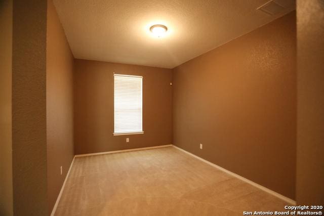 empty room with carpet floors and baseboards