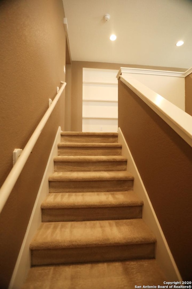 staircase with recessed lighting