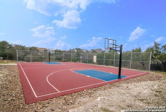 view of basketball court with community basketball court and fence